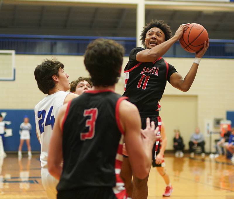 Batavia’s Brandon Redmond (11) drives to the hoop against Geneva’s Luke Matan (24) during a basketball game at Geneva High School on Friday, Dec 15, 2023.