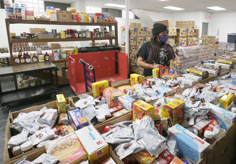 Antionette Lyons, volunteer at the Illinois Valley Food Pantry sorts through food to distribute to clients on Thursday Jan. 6, 2022 in La Salle. The food pantry had an extremely successful holiday season but is running into some difficulties paying their utility bills.