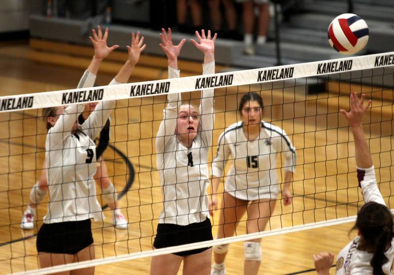Kaneland’s Meredith Milz (9) and Gabriella Gatz (8) go up for a block during a home game against Morris on Thursday, Oct. 13, 2022.