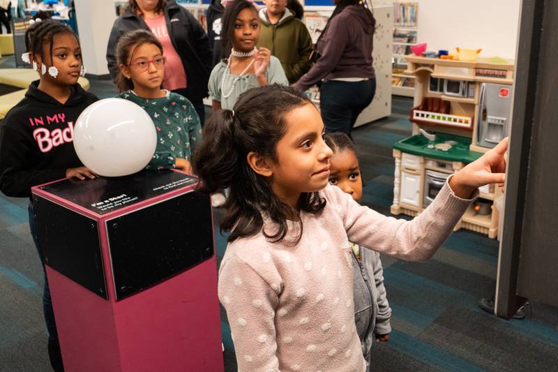 The Joliet Public Library at 150 N. Ottawa St. in Joliet is hosting an all-ages, interactive Exoplanet exhibit from NASA through Feb. 28. Pictured are Merda Ramirez, Rheah Needon, Miranda Espina and Leah Needon.