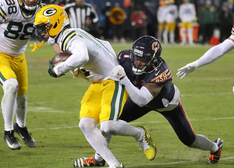 Chicago Bears cornerback Jaylon Johnson tries to bring down Green Bay Packers wide receiver Matthew Golden during their NFL Wild Card game Saturday, Jan. 10, 2026, at Soldier Field in Chicago.
