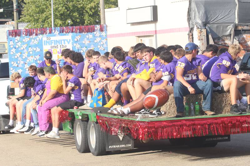 Members of the Mendota High School football team ride down Indiana Avenue during the homecoming parade on Friday, Oct. 3, 2025