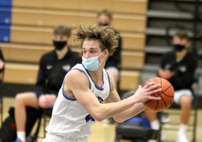 St. Charles North's Max Love grabs a rebound during a home game against Geneva on Wednesday, Feb. 17, 2021.