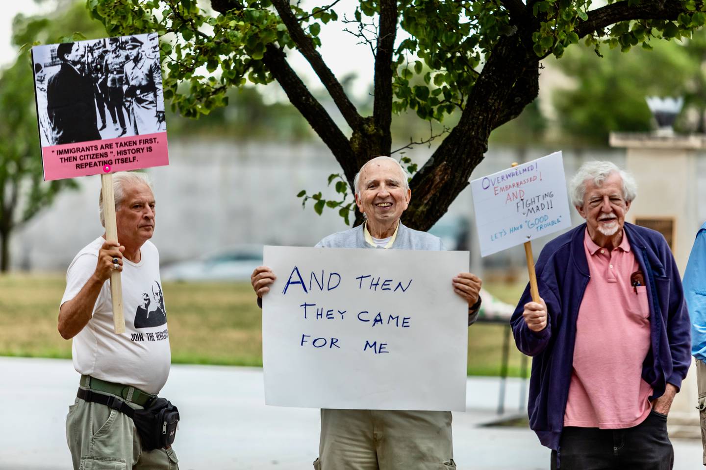 Keith Larson, Lanny Younger, and Ted Thompson participate in the Good Trouble Lives On event in Downtown Joliet on July 17, 2025.