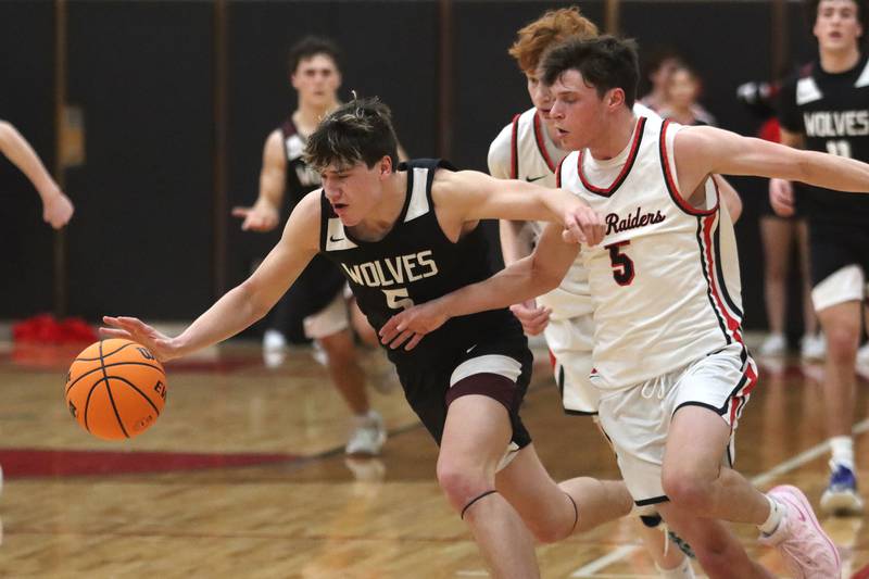 Huntley’s Zachary Rysavy, right, battles Prairie Ridge’s Eli Loeding in varsity boys basketball on Tuesday, Feb. 18, 2025, at  Huntley High School in Huntley.