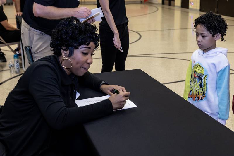 Nicor Outreach Coordinator Amber Brown checks-in Blaise Durham, who will receive a new winter coat from Nicor Gas, in collaboration with Operation Warm, at T. E. Culbertson Elementary School on Nov. 7, 2025.