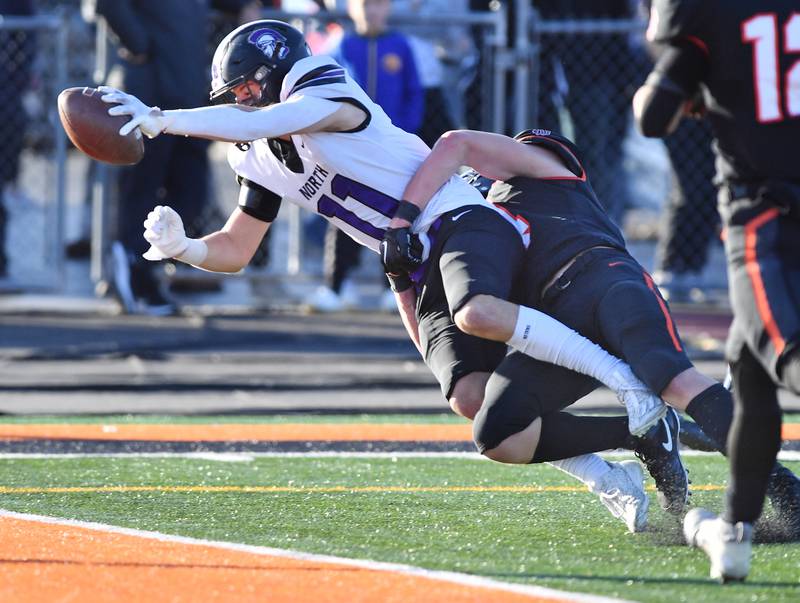 Downers Grove North's Charlie Cruse (11) stretches the ball into the end zone for a touchdown during an IHSA Class 7A quarterfinal game against Lincoln-Way West on Nov. 11, 2023 at Lincoln-Way West High School in New Lenox.