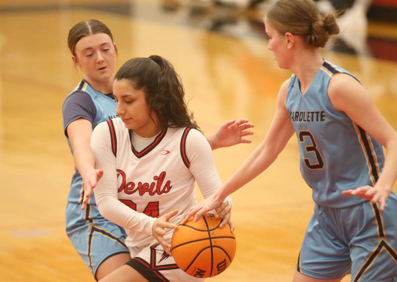 Hall's Natalia Zamora has the ball knocked away from her by Marquette's Morgan Nelson on Thursday, Feb. 13, 2025 at Hall High School.