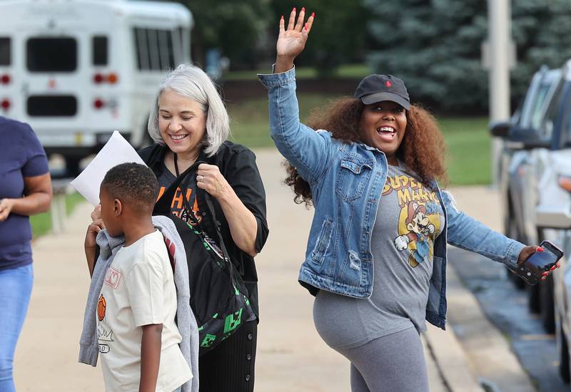 Moms wave goodbye to their kids Thursday, Aug. 17, 2023, as they arrive for the first day of the new school year at Gwendolyn Brooks Elementary School in DeKalb.