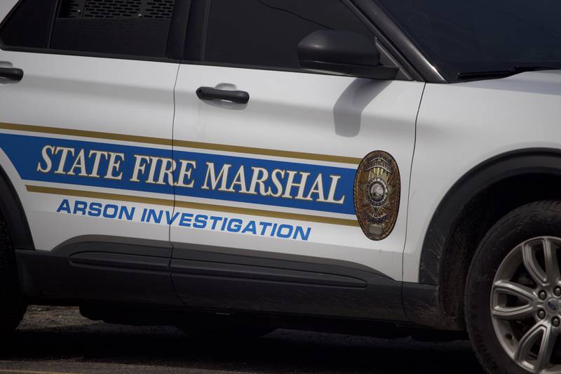 A vehicle from the Illinois State Fire Marshal's Office at the scene of the aftermath of a fire on Monday, April 14, 2025, that destroyed a building at the site for Rovanco Piping Systems, 20535 SE Frontage Road, Joliet.