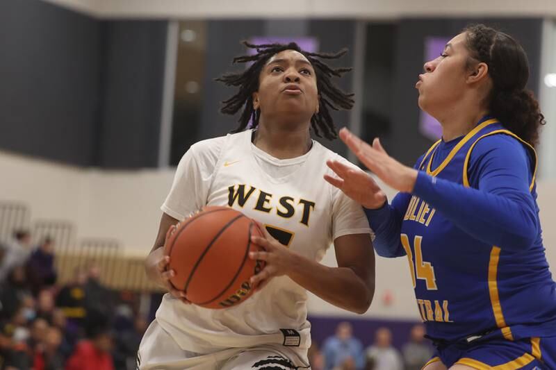 Joliet West’s Mariah Shelton goes in for the basket against Joliet Central at Joliet Junior College.