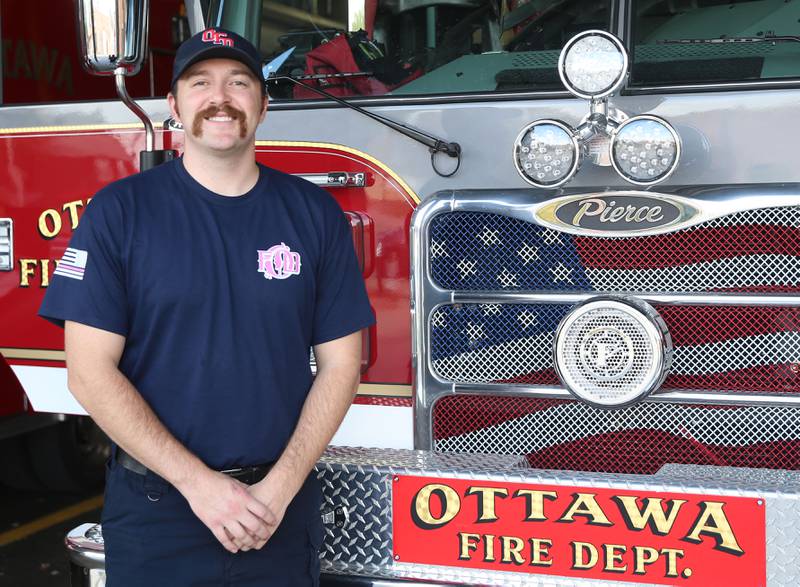 Veteran and Ottawa fireman Brian Ksaizak, poses for a photo next to a fire engine on Monday, Oct. 6, 2025 at the Ottawa Fire Station.