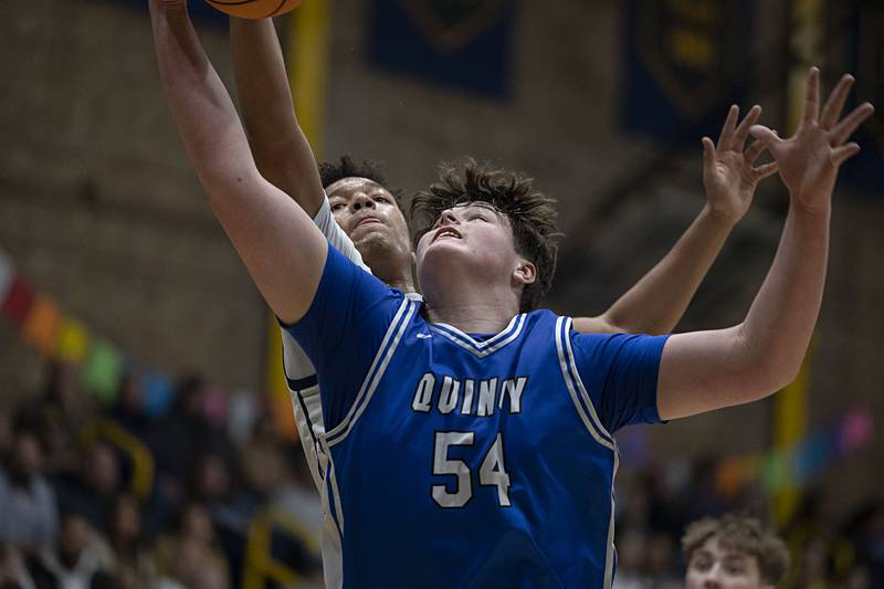 Quincy’s Brennan Lepper and Sterling’s Koby Bell battle for a rebound Friday, Jan. 30, 2026.