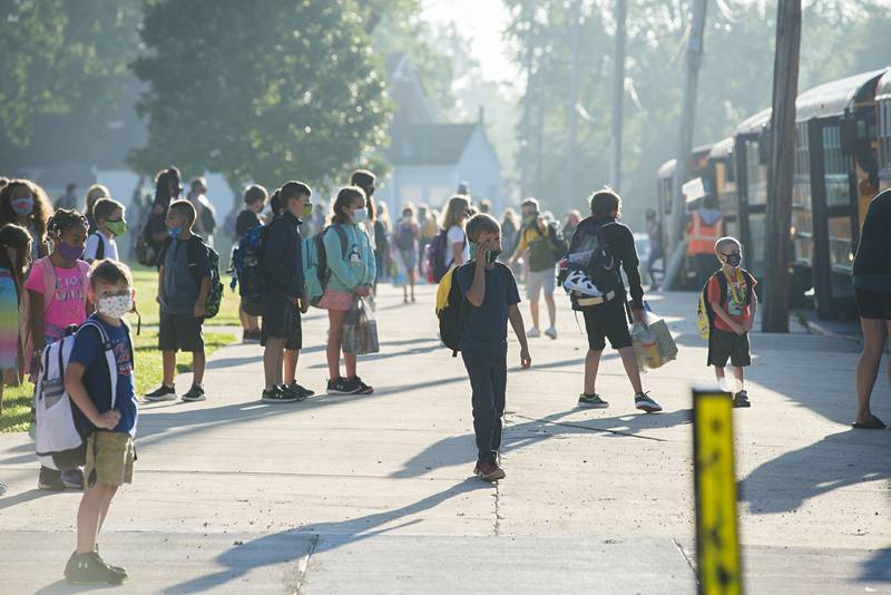 Students wait to board the busses at Washington School in Dixon Monday morning which will take them to others schools in the district.