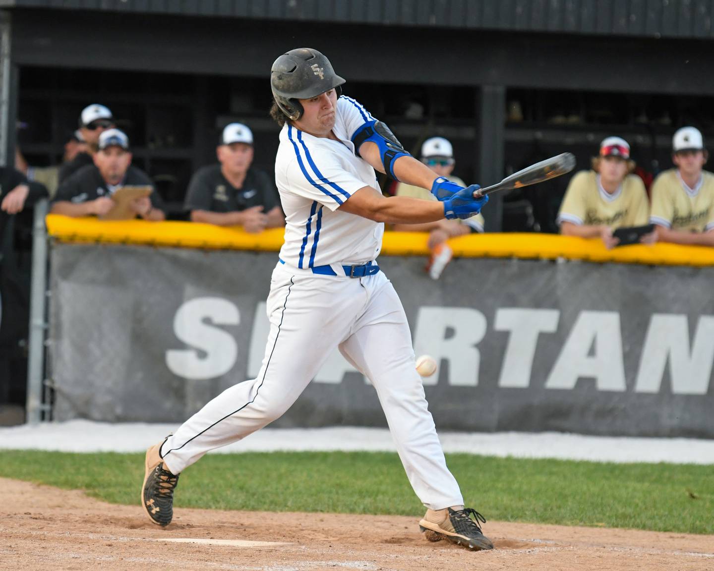 St. Francis TJ McMillen makes contact with the ball during the sectional play off game on Wednesday June 1st while taking on Sycamore in Sycamore but was tagged out at first.