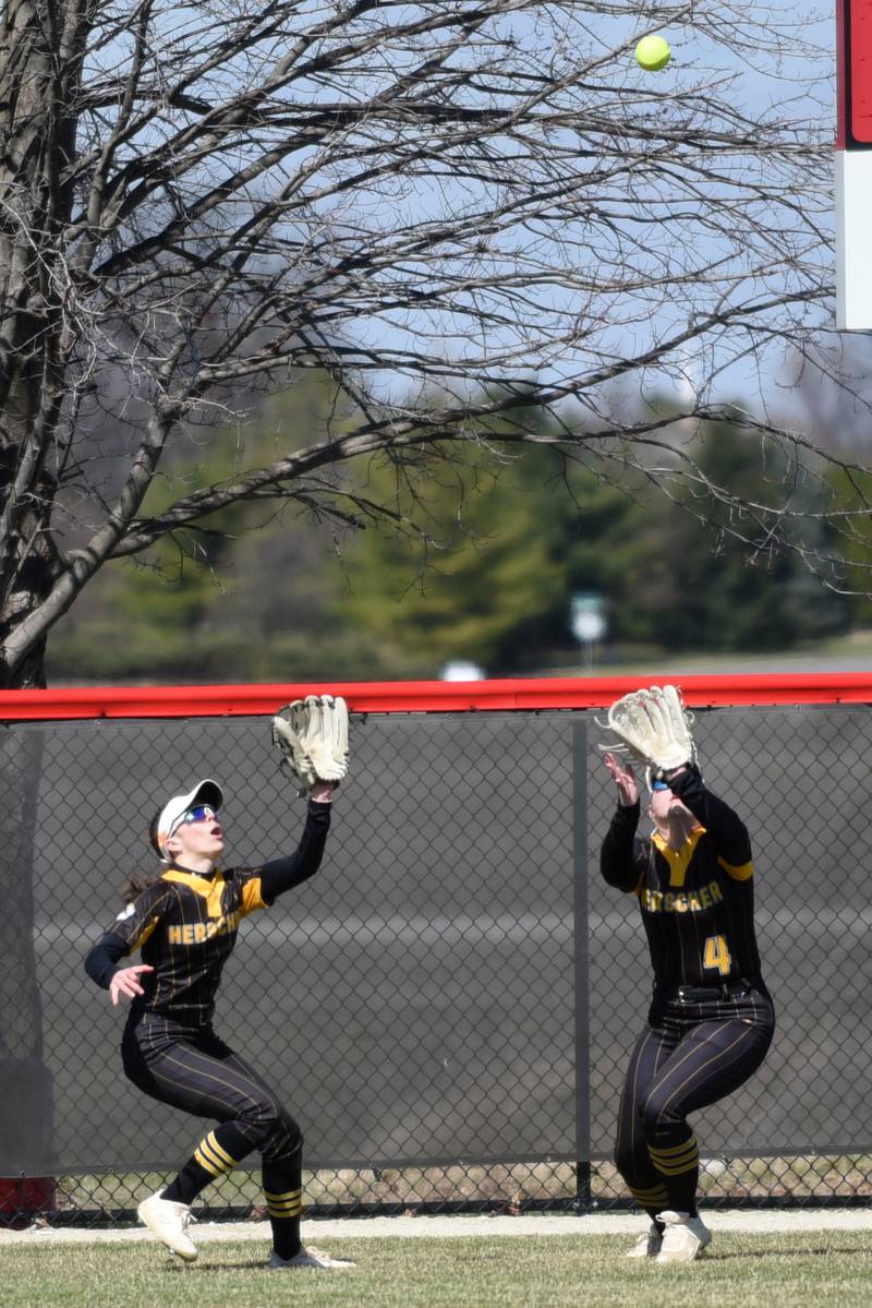 Herscher's RyLyn Adams, left, and Liv Wilkins camp under a fly ball during a game at Bradley-Bourbonnais Monday, March 24, 2025.