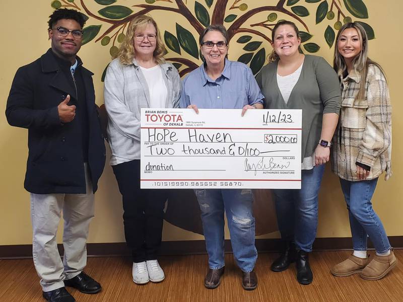 Brian Bemis Toyota of DeKalb employees donating a $2,000 check to Hope Haven