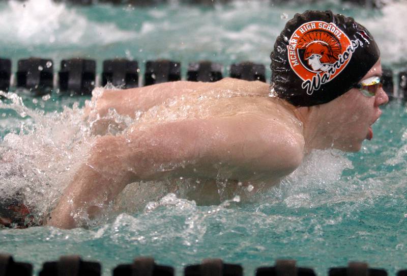 McHenry’s Ian Boland swims the 100-Yard Butterfly during the Fox Valley Conference Swimming Championships at Woodstock North High School Saturday.