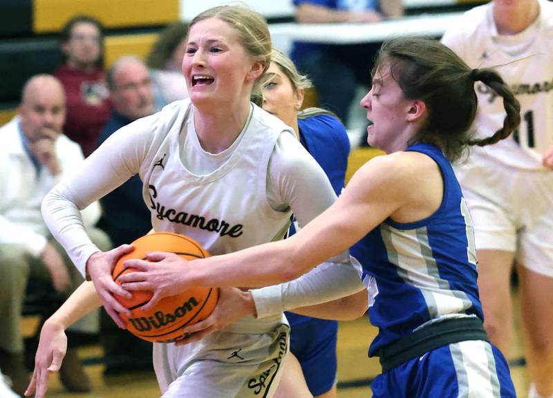 Sycamore's Lexi Carlsen goes to the basket against St. Francis' Dolly Smith during their game Thursday, Jan. 4, 2023, at Sycamore High School.