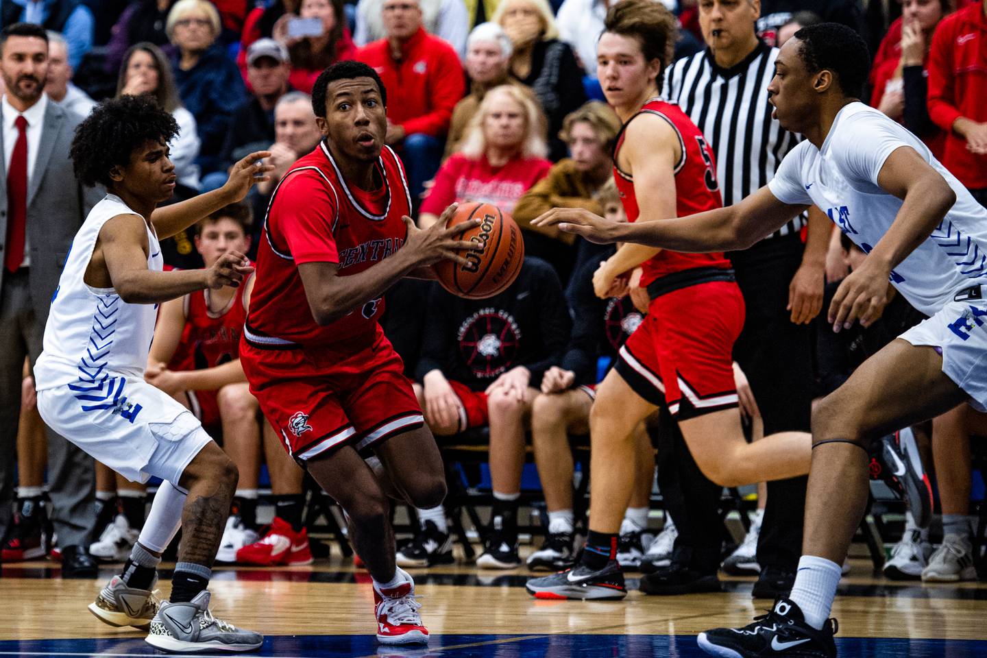 Lincoln-Way Centrals Korey Cagnolotti pushes past  Lincoln-Way Easts Kaiden Ross and Kyle Olagbegi  Friday Dec. 2, 2022 at Lincoln-Way East  High School in Frankfort