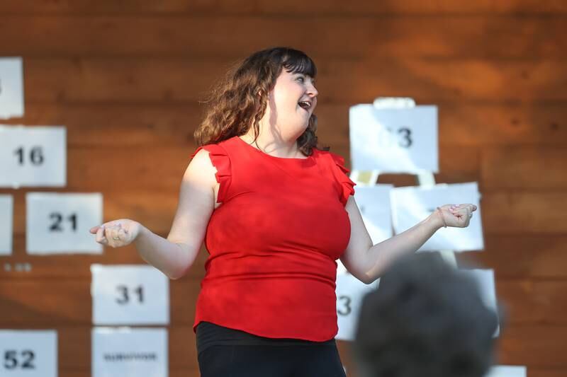 GreenRoom Improv cast member Jess Smith celebrates after being chosen by the audience to do the next improv during the show hosted by the Morris Library at Goold Park on Friday, Aug. 11, 2023 in Morris.