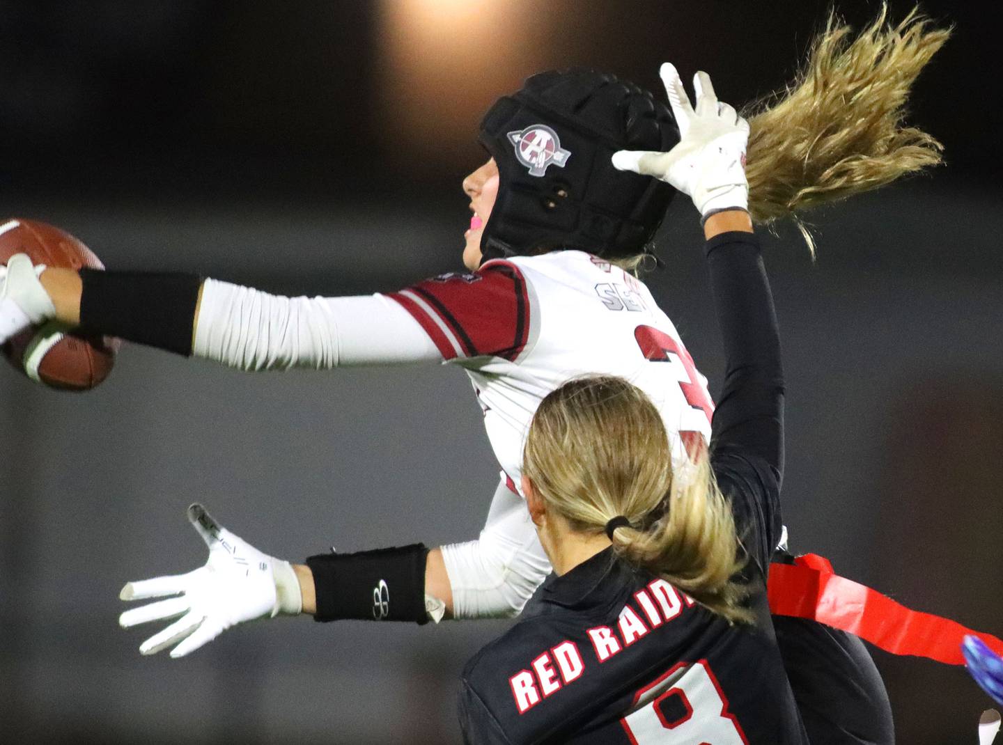 Antioch’s Reese Queensland snags an interception in front of Huntley’s Addison Avi in IHSA Regional varsity flag football action at Crystal Lake Central High School in Crystal Lake on Wednesday, Oct. 8, 2025.