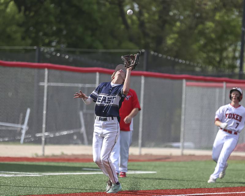 Oswego East's Jax Wellehan (5) catches a popup at third during baseball game between Oswego East at Yorkville. Monday, May 12, 2025 in Yorkville.