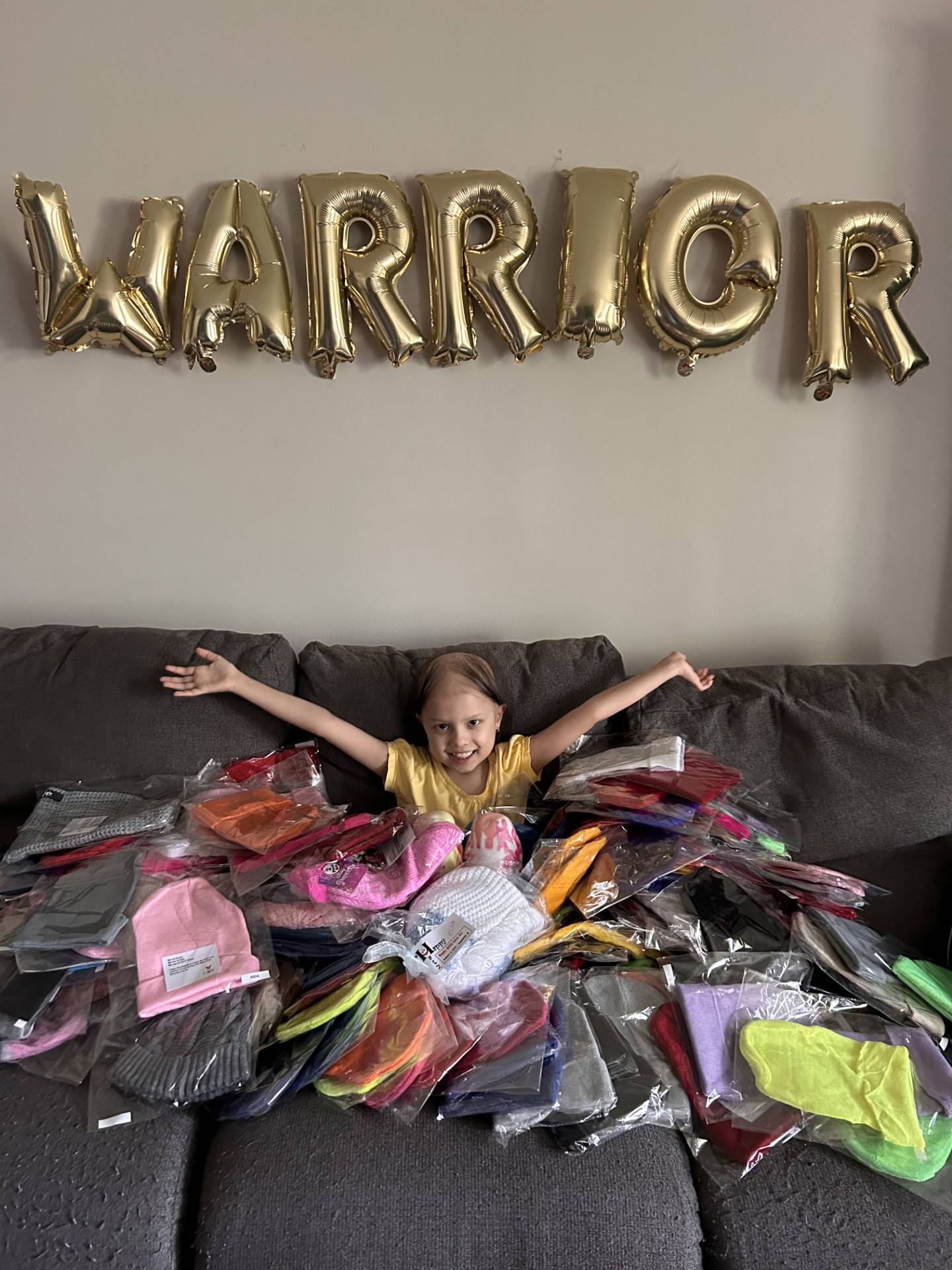 Lilley Sloniker poses with some of the beanies she collected last year for Lurie's.
