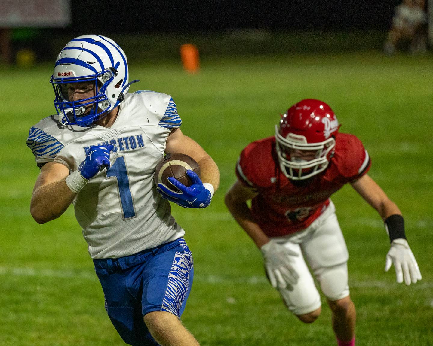 Casey Etheridge (1) of Princeton runs ball as Hunter Edgcomb (6) of Hall trails on Friday, Oct. 3, 2025 at Richard Nesti Stadium in Spring Valley.