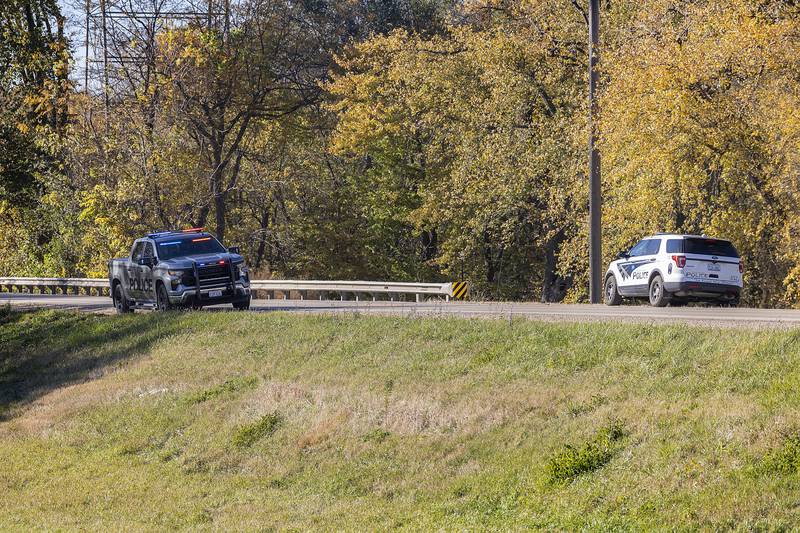Officers patrol near the Route 30 bridge outside of Rock Falls Friday, Nov. 1, 2024, during a man hunt for a subject with a warrant.