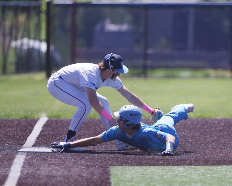Harvest Christian's Kyle Ziebell tags out Marquette's Alle Novotney at third base in the first inning at the Class 1A Sectional Final on Saturday May 25, 2024 in Elgin.