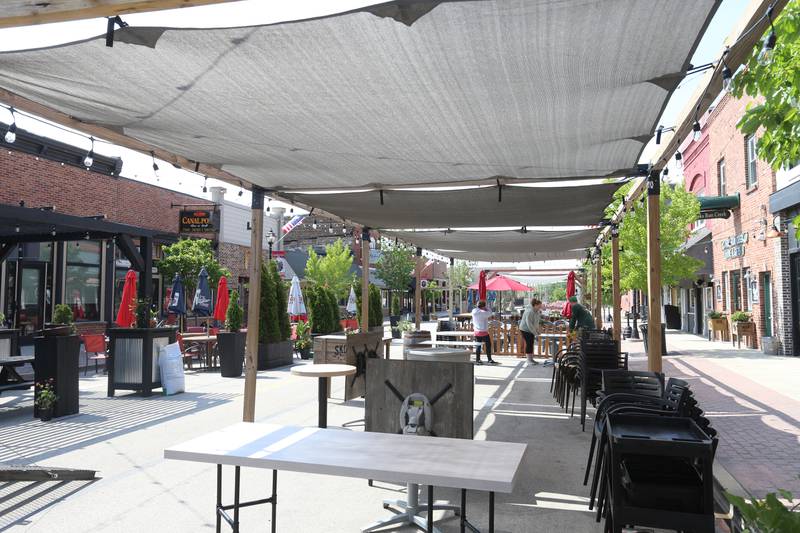Utica businesses kicked off the outdoor dining season by setting up patio furniture, flowers, decorations and canopies on Thursday, May 8, 2025 for customers on Mill Street downtown Utica. The outdoor dining season on Mill Street runs through October.