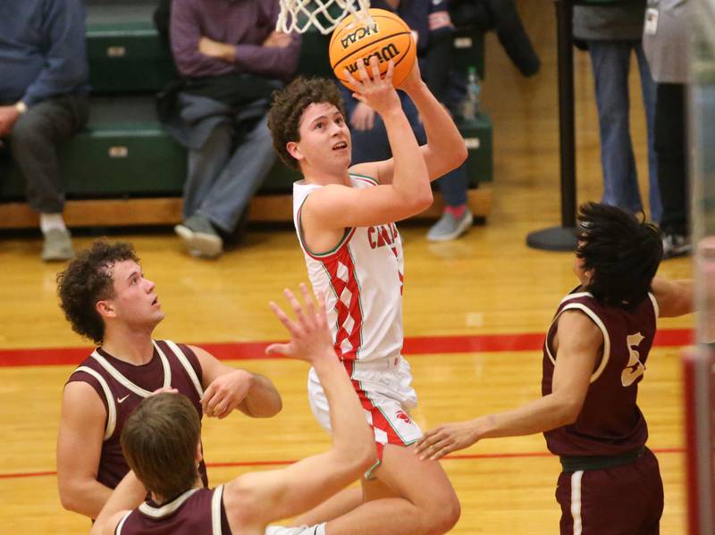 L-P's Mikey Hartman eyes the hoop as Morris defenders Colin Pfeifer, Jack Wheeler and Luis Loza back off on Friday, Dec. 6, 2024 in Sellett Gymnasium at L-P High School.