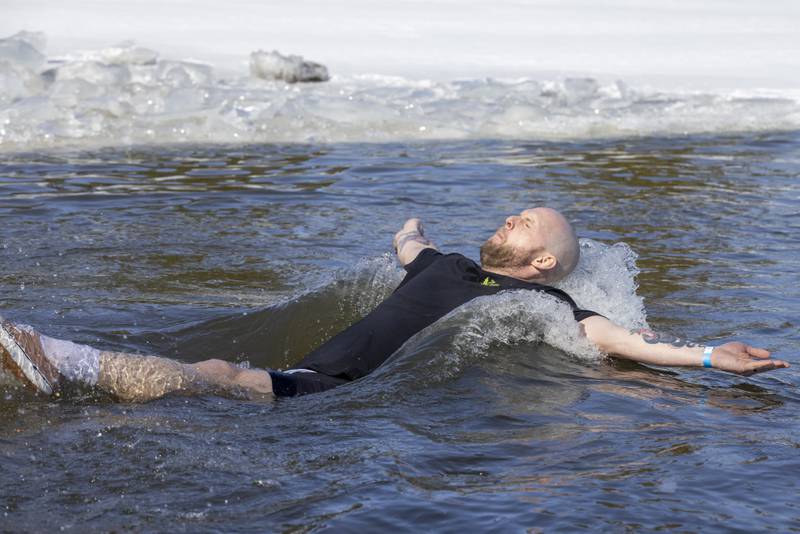 Billy LaShonse dives backwards into the frigid water during the Polar Plunge for Special Olympics on February 22, 2025 at Lake Mendota.