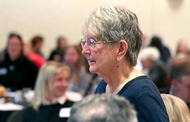 Women of Accomplishment honoree Jane Hapeman comes to the stage to be recognized Tuesday, Oct. 18, 2022, during the Athena and Women of Accomplishment Award Reception at the Barsema Alumni and Visitors Center at Northern Illinois University in DeKalb.