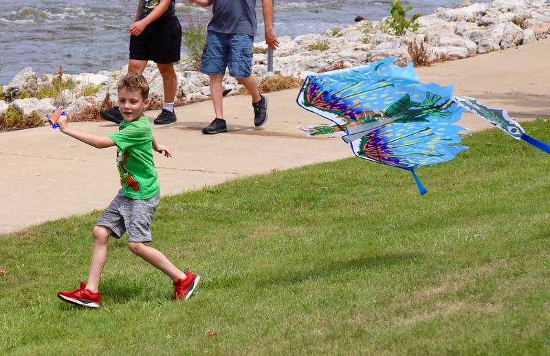 A boy flies a kite at Yorkville River Fest on Saturday, July 19, 2025.