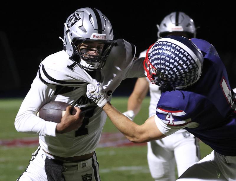 Kaneland's Jalen Carter tries to pull away from Belvidere North's Ben Bucher Friday, Nov. 7, 2025, during their Class 5A second round playoff game at Belvidere North High School.