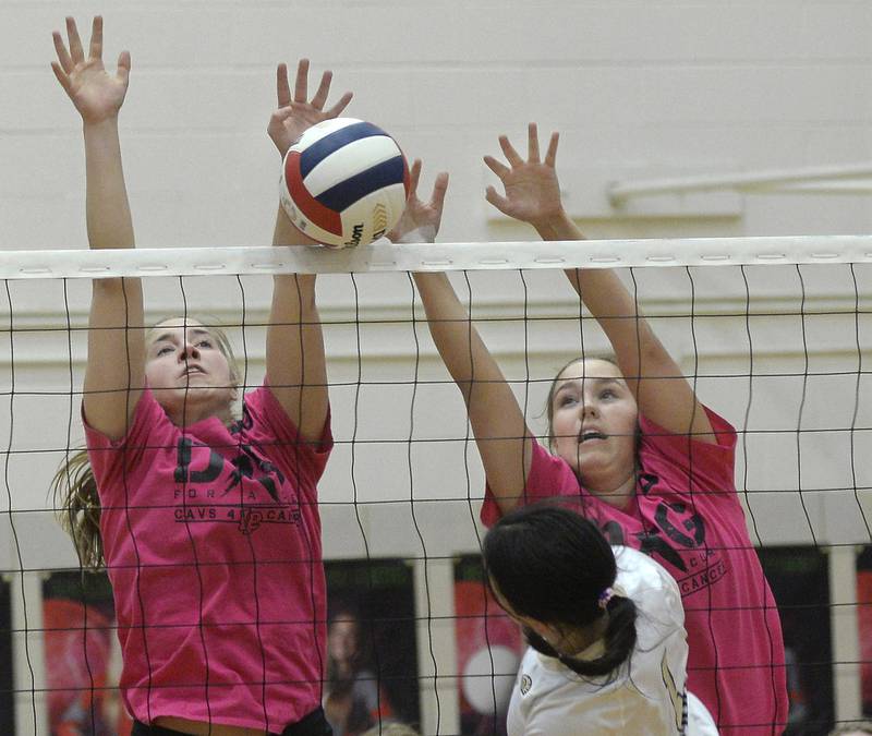 LaSalle Peru’s Addison Urbankski and Emma Garretson team up to block a shot by Sycamore’s Grace Lichthardt during the first match on Tuesday, Oct. 11, 2022 in Sellett Gymnasium.