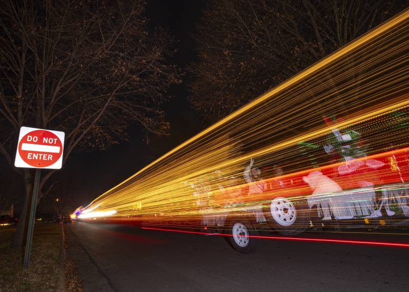 A long exposure photo of the parade float traffic going down St. Paul Street.