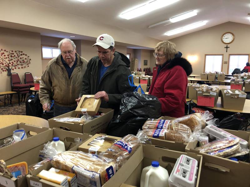 Volunteers help the Putnam County food pantry distribute Christmas baskets to families at the United Church of Christ in Granville on Saturday, Dec 17, 2022.