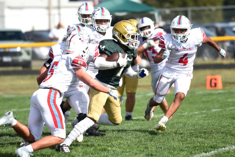 Bishop McNamara's Malachi Lee, center, runs through the Marian Central defense during a game at Bishop McNamara Saturday, Oct. 4, 2025.