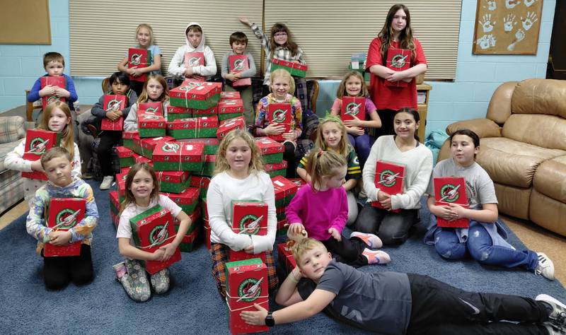 The United Church of Sandwich’s United Kids After School program members filling Operation Christmas Boxes