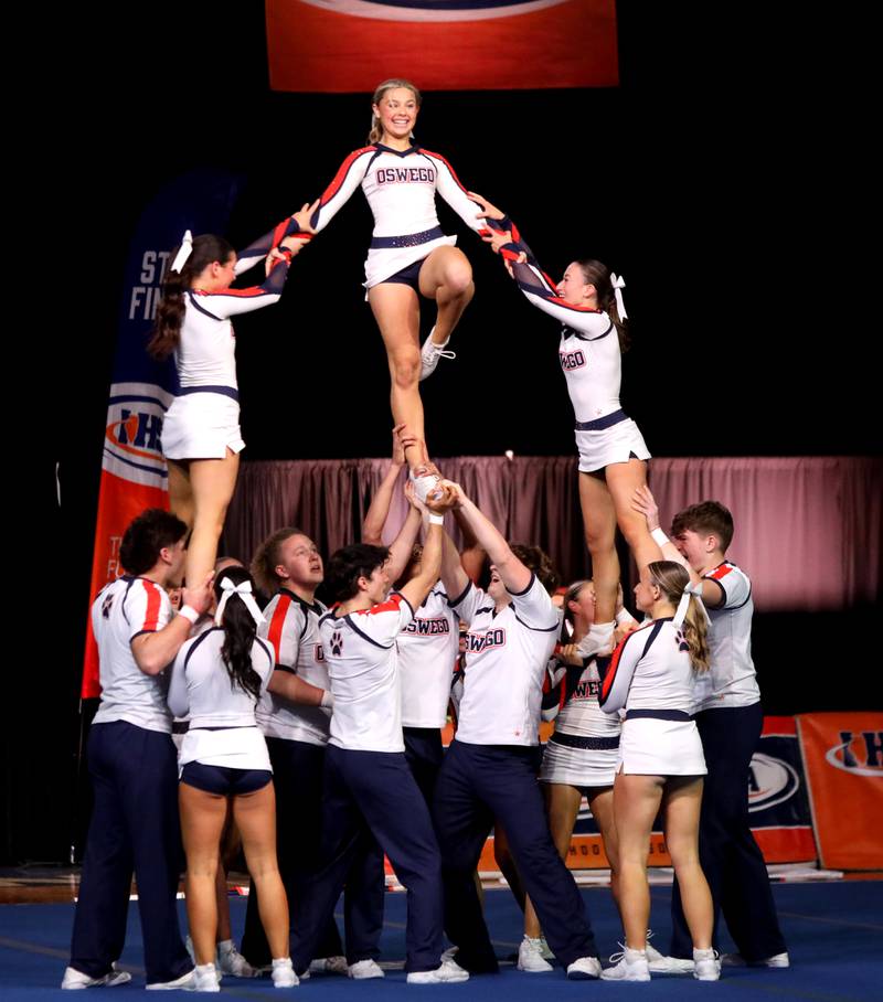 Members of the Oswego cheerleading team compete in the coed team division of the IHSA State Finals on Saturday, Feb. 8, 2025 at Grossinger Motors Arena in Bloomington.