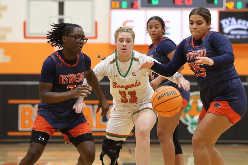 Oswego’s Madelyn-Jordyn Mensah (3), Natalia Wheeler (35) and Plainfield East’s Emma Rodgers (33) go for the loose ball on Tuesday, Jan. 13, 2026 in Plainfield.
