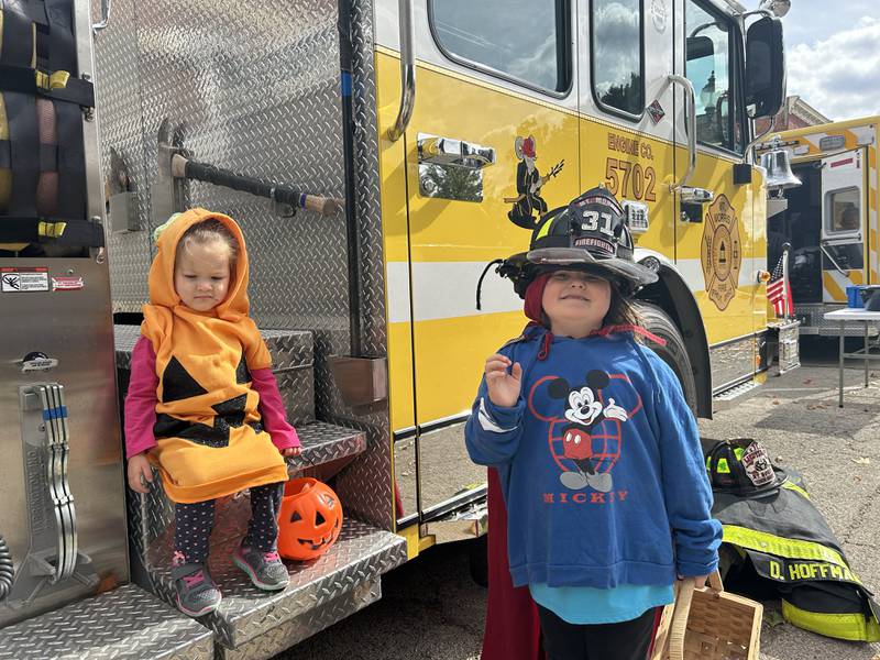Thea and Sophie McHorter, ages 6 and 2, checked out a Mt. Morris fire engine in their Halloween costumes on Sunday, Oct. 13, 2024 at the Evangelical Free Church of Mt. Morris' Trunk or Treat held in conjunction with the Fall Family Festival in the village's square. Thea and Sophie attended the event with their grandmother.
