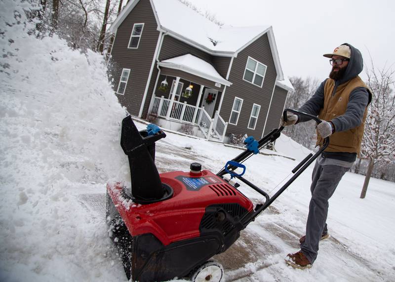 Matt Oxnevad snow blows his driveway in St. Charles on Saturday, Jan. 6, 2023. The Kane County Area received about one to two inches of snowfall late Friday night into Saturday morning.