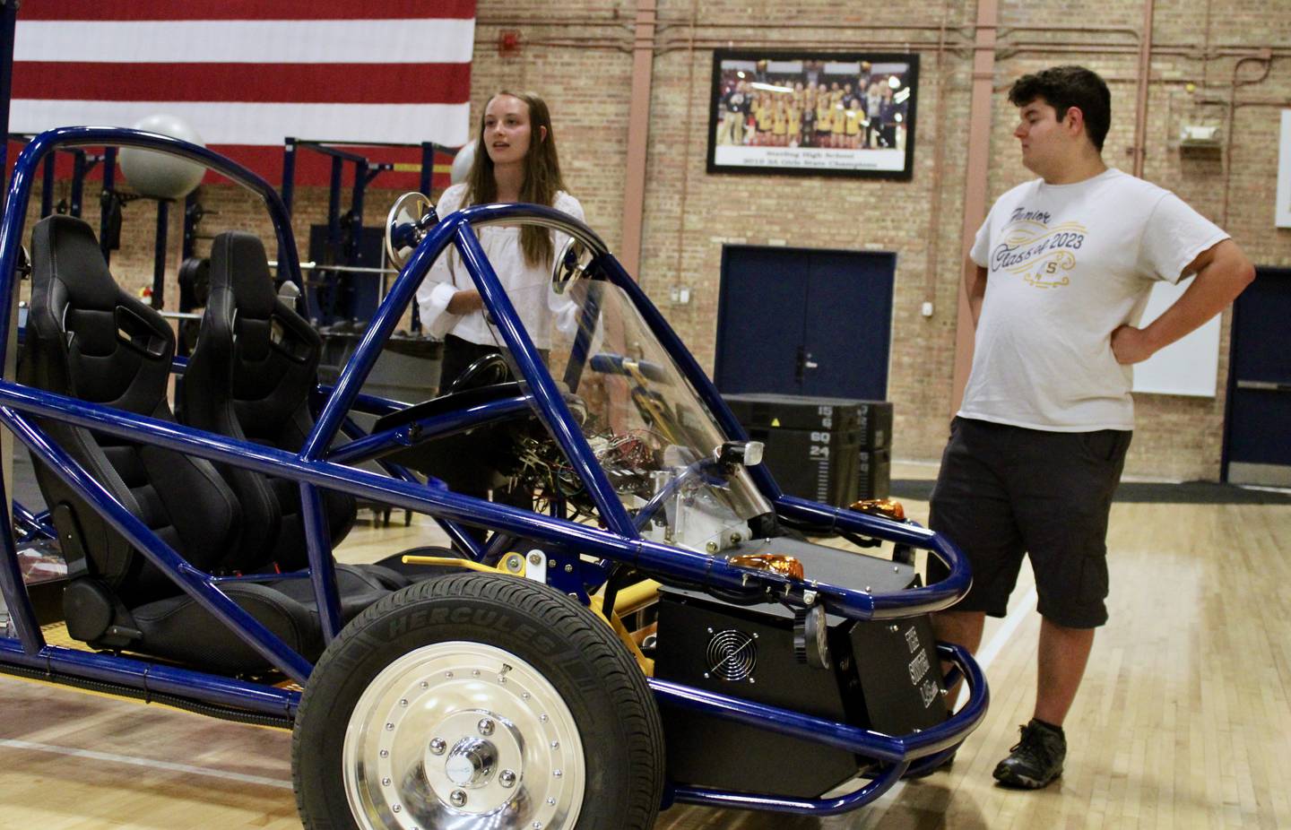 Paige Geil and Zach Shapiro, two members of a Sterling High School physics class whose project was to assemble an electric vehicle, talk about their experiences during a demonstration on Wednesday for the Sterling Public Schools board of education.