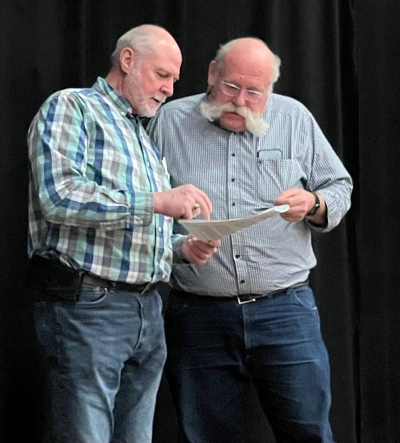 Actor Tom McElroy (left) and Performing Arts Guild technical director Jeff Bold go over the sound and lighting instructions for the upcoming presentation of “Heaven, How I Got Here” at the Pinecrest Grove Community Theatre in Mt. Morris. The play will be presented by the Evangelical Free Church of Mt. Morris in collaboration with the PAG on March 22, 23, and 24.