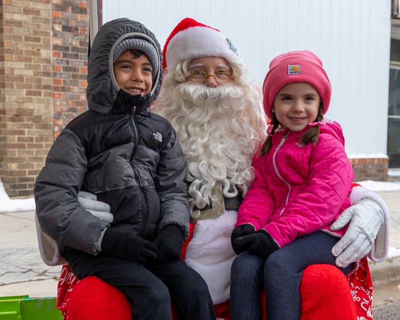 Sean and Stella Arteaga sit on Santa's lap and pose for photo on Saturday, December 6, 2025 on Illinois Avenue in Mendota.