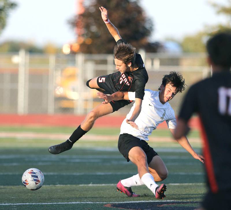 DeKalb's Tyler Diedrich (left) and Sycamore's Ethan Royer get tangled up during their game Tuesday, Oct. 4, 2022, at DeKalb High School.